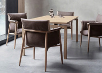 Brown Embrace chairs with cushion and armrests.